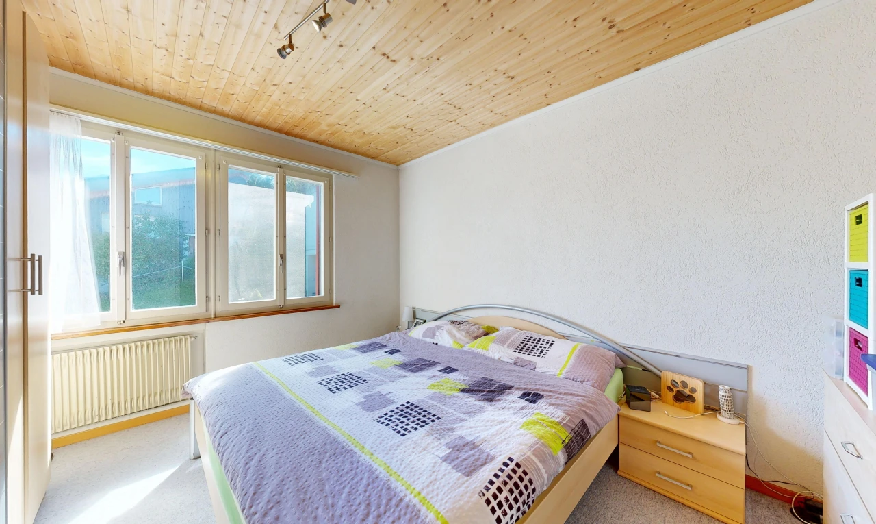 room with wood ceiling, radiator, light colored carpet, and rail lighting