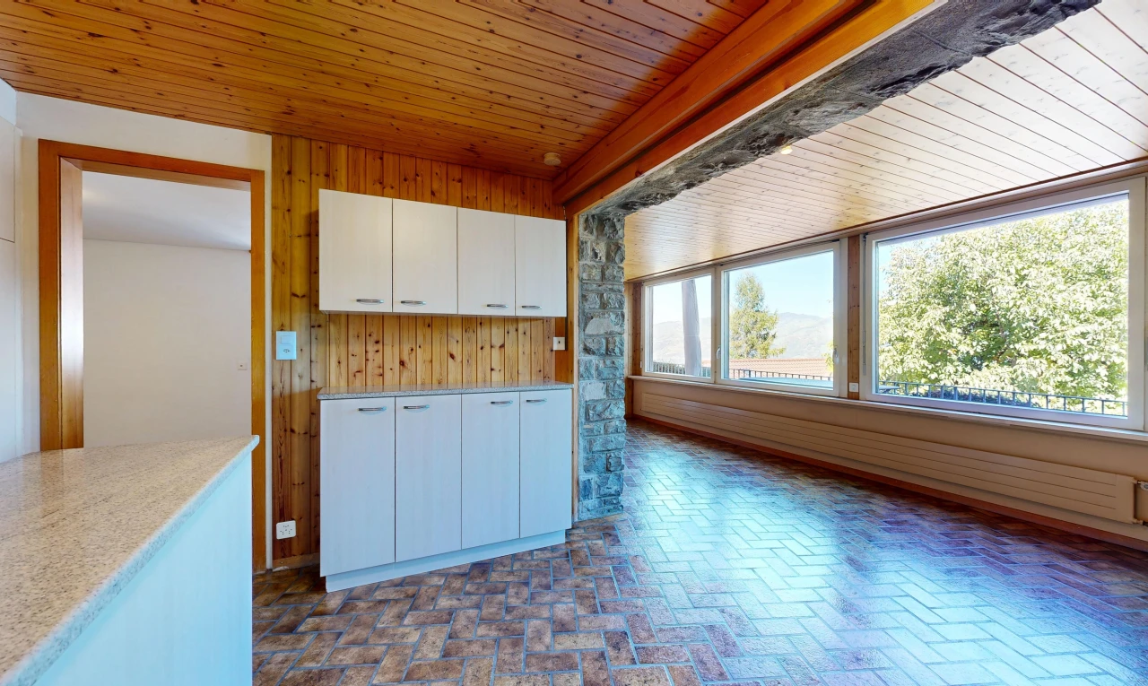 kitchen with wood ceiling, wooden walls, and brick flooring