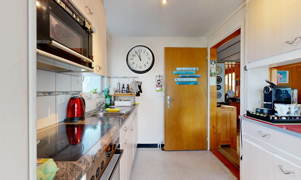 kitchen featuring black appliances, decorative backsplash, and white cabinets