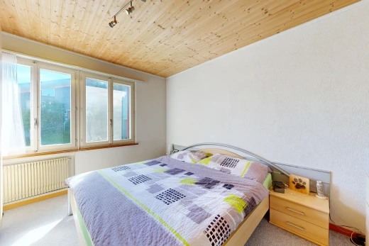 room with wood ceiling, radiator, light colored carpet, and rail lighting