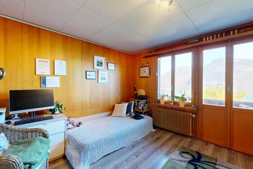 chambre avec radiateur, accès à l'extérieur, télévision, wood finish floor, et sol en finition bois