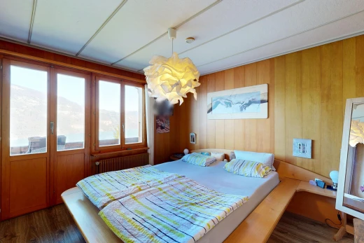 room featuring wooden walls, radiator, and dark wood-style floors