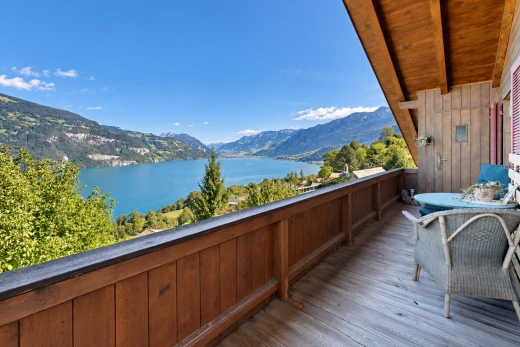 balcony featuring a water and mountain view