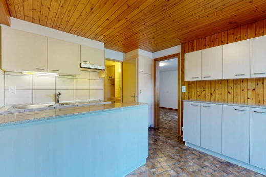 kitchen featuring light countertops, wooden ceiling, backsplash, and wood walls