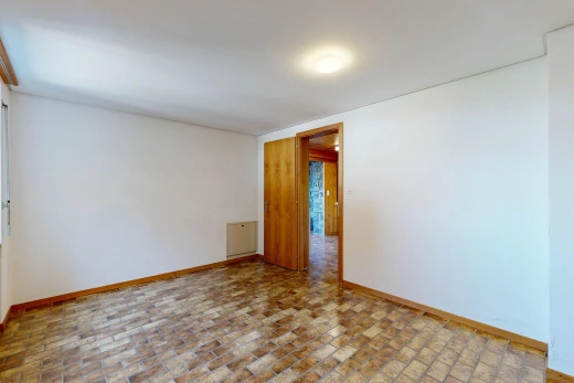 unfurnished room with baseboards and brick patterned flooring