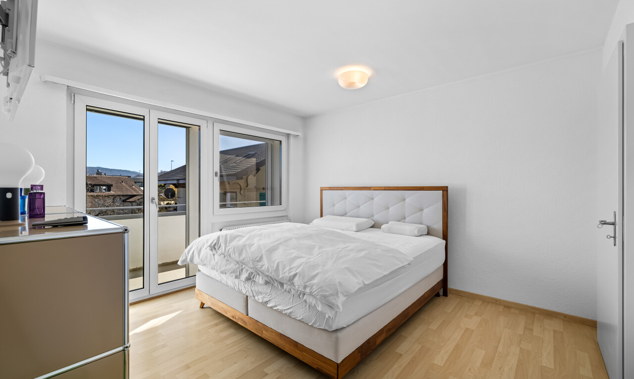 zimmer / schlafzimmer mit holzfußboden, gipskartonwand, und natürliches licht