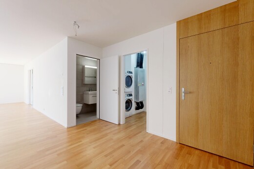 pièce vide avec lave-linge et sèche-linge superposés, light floor, wood finish floor, sol en finition bois, et inside property