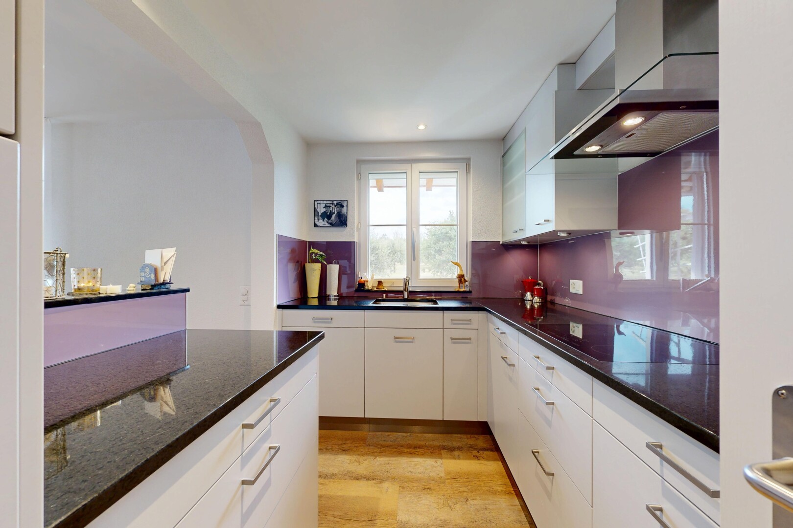 küche mit dunstabzugshaube, dark countertops, light floor, einbauleuchten, und wood finish floor