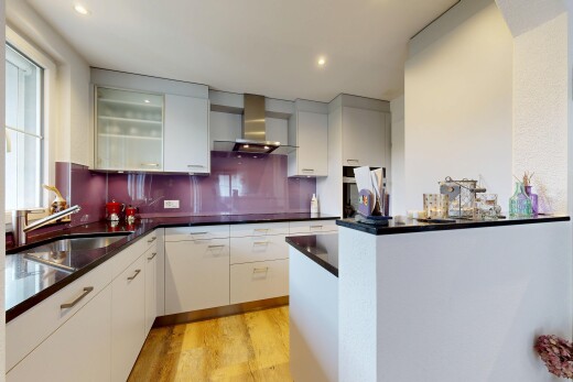 kitchen with light wood-style flooring, tasteful backsplash, recessed lighting, glass fronted cabinets, and modern cabinets