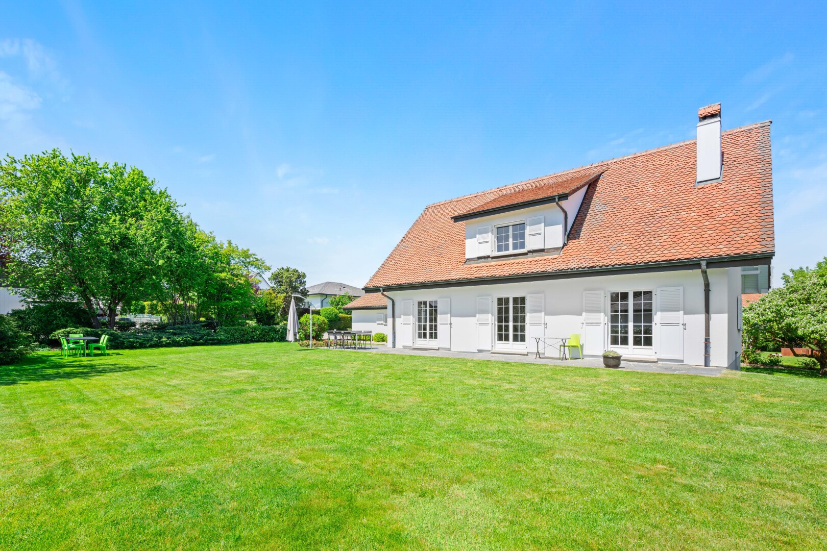 outdoor house with a yard and a chimney