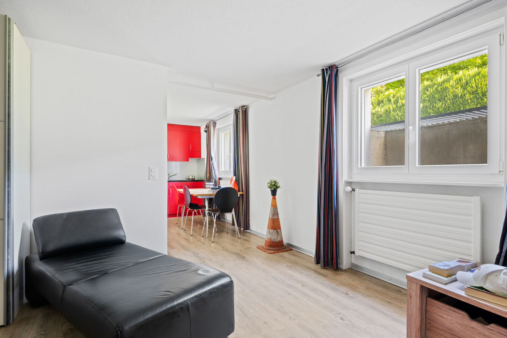 living room with light wood-style floors and radiator heating unit