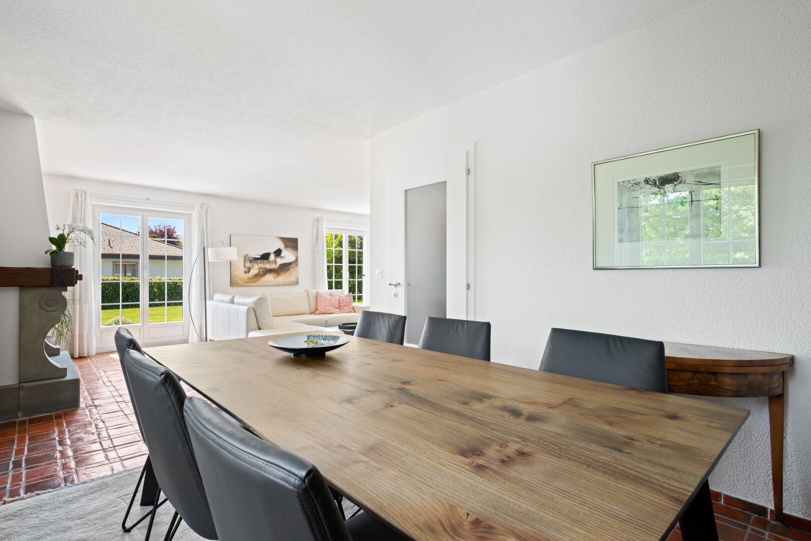 dining room featuring brick flooring and healthy amount of natural light