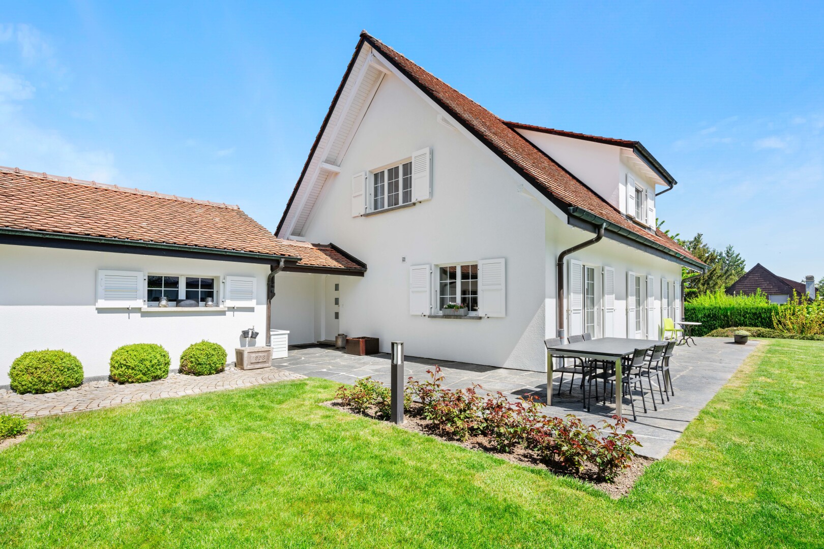 outdoor house featuring a lawn, a patio, and stucco siding