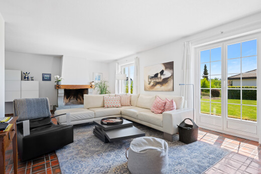 living area featuring a fireplace with raised hearth