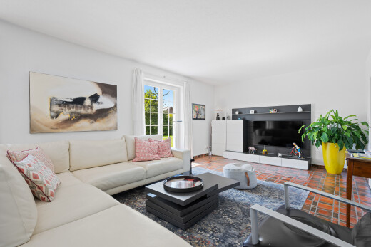 living room featuring brick floors