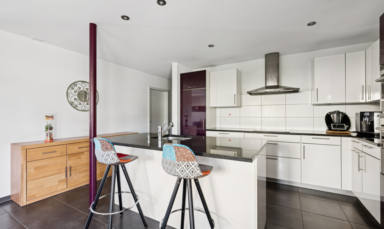 küche mit dark floor, dark countertops, dunstabzugshaube, schränke mit flachen paneelen, und flat panel cabinets