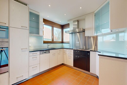 kitchen with glass insert cabinets, dark countertops, stainless steel appliances, and recessed lighting