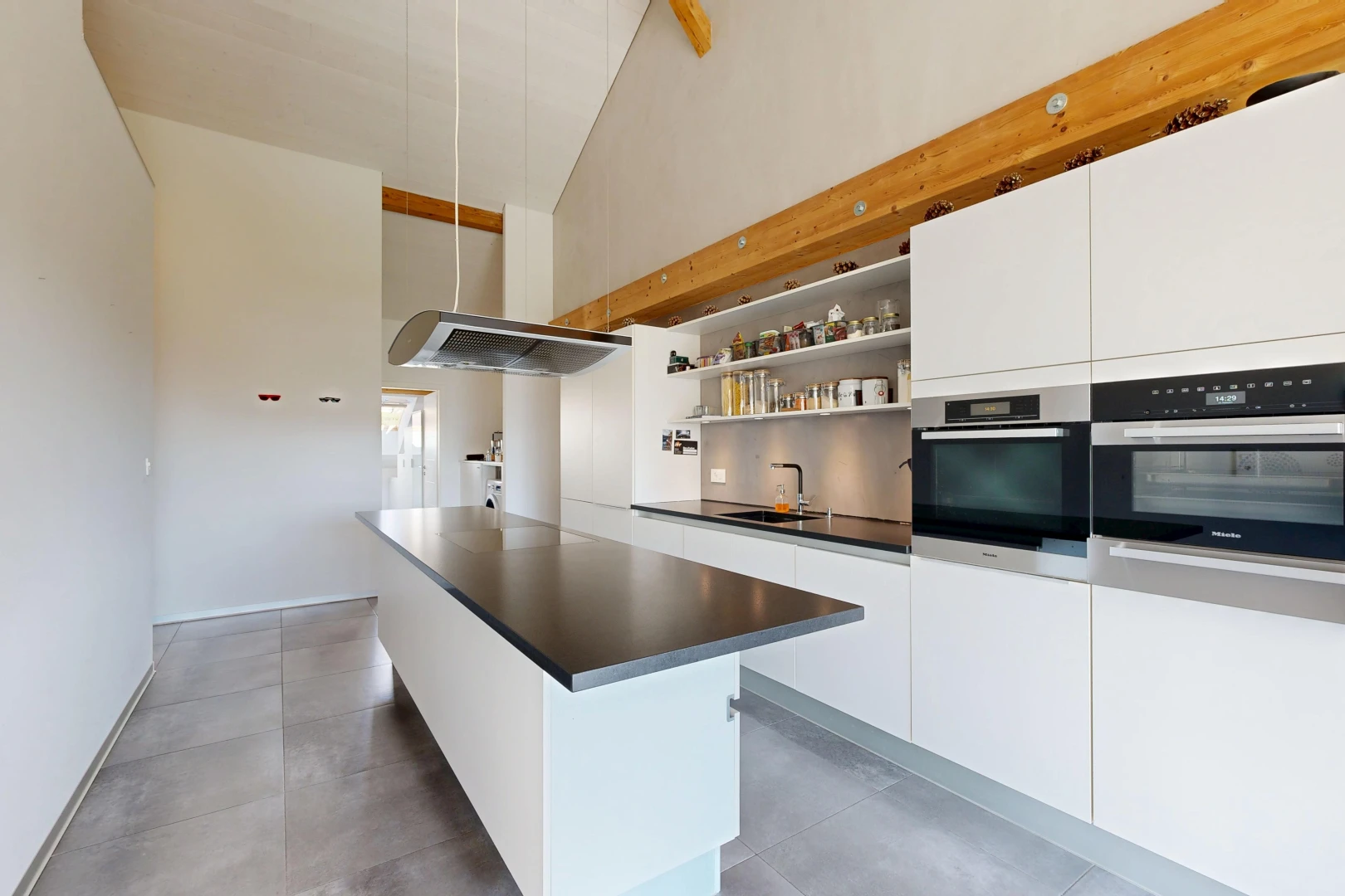 cuisine avec dark countertops, plans de travail, white cabinets, armoires blanches, et high ceiling