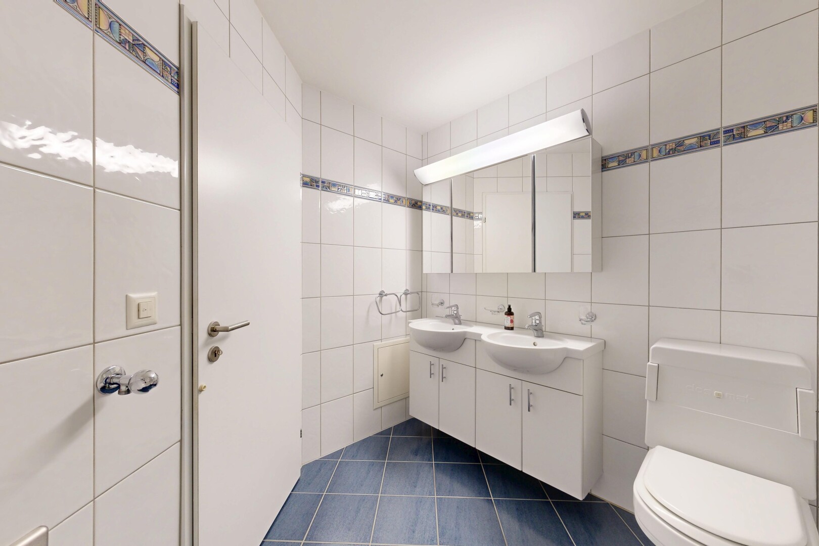 salle de bains avec double vasque, mur en carrelage, tile wall, toilette, et sol en carrelage