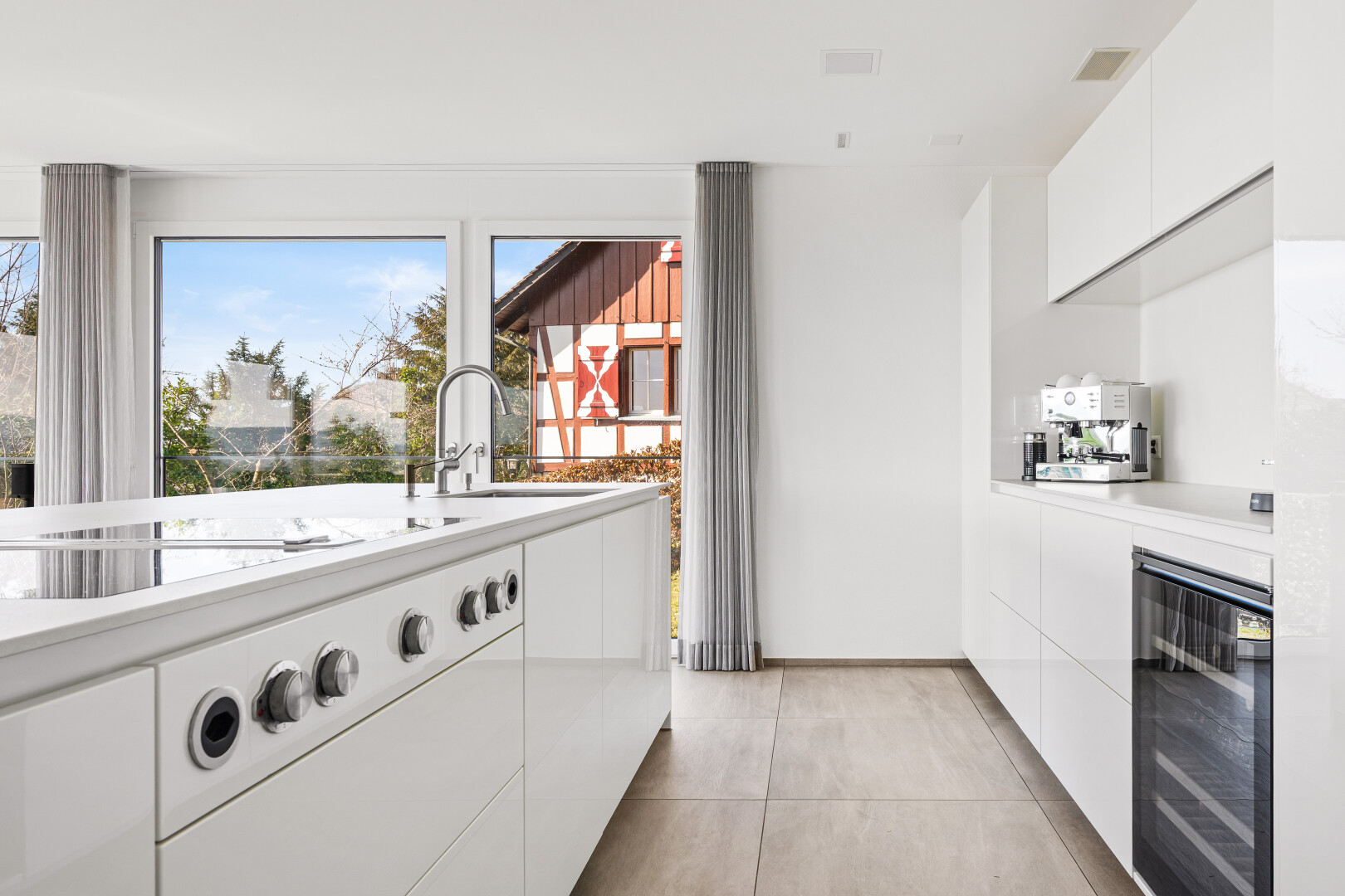 kitchen featuring white cabinetry, modern cabinets, and wine cooler
