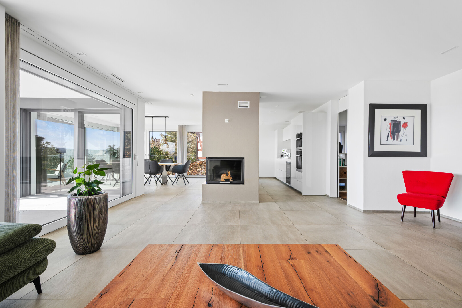 living room with concrete floors and a multi sided fireplace