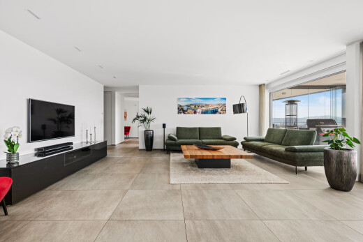 living room featuring concrete flooring and floor to ceiling windows
