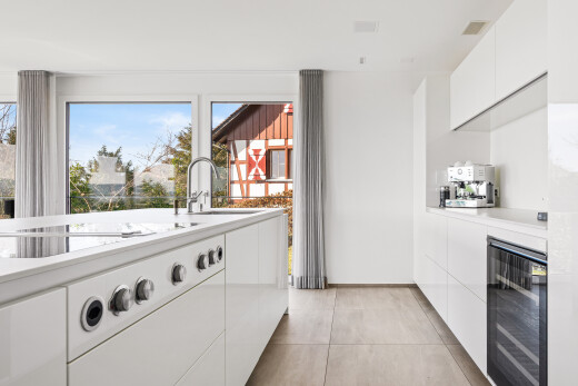 kitchen featuring white cabinetry, modern cabinets, and wine cooler