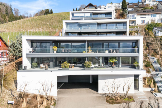 view of property featuring a balcony and a carport