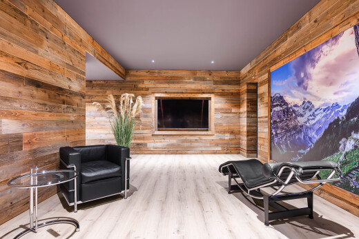 workout area with wood walls, wood finished floors, and a mountain view