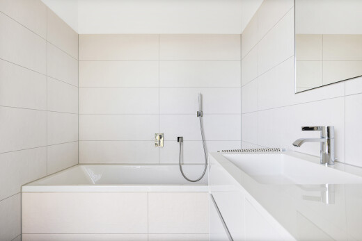 bathroom with vanity, tiled bath, tile walls, and a shower