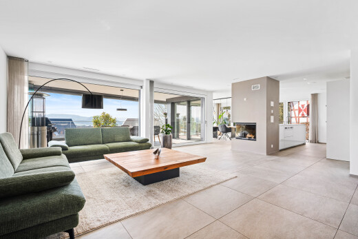 living room featuring concrete floors and a fireplace