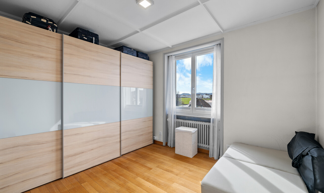 room / bedroom with light wood-type flooring and radiator heating unit