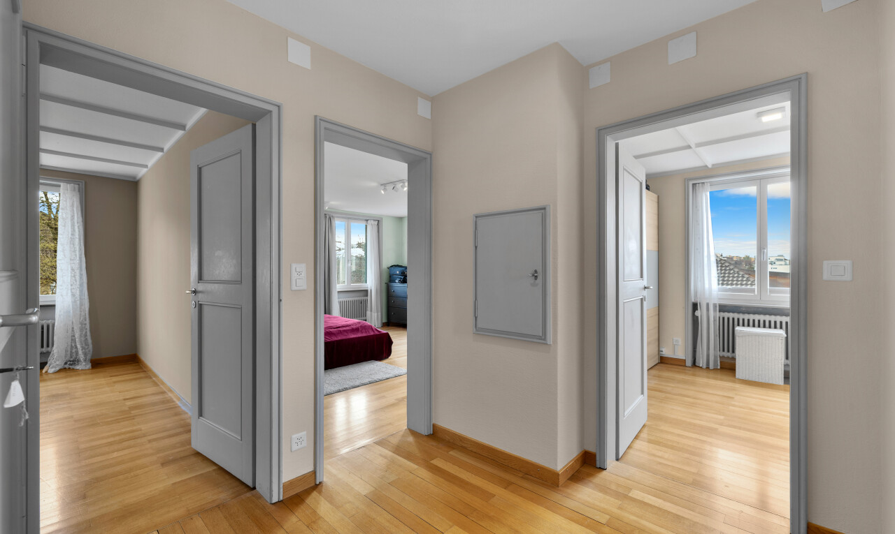 hallway with plenty of natural light, light wood-style floors, and radiator heating unit