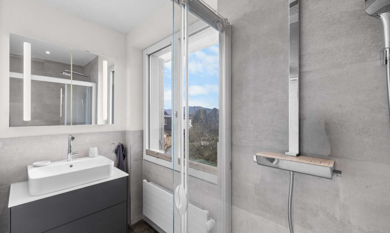 bathroom featuring vanity, a stall shower, and radiator