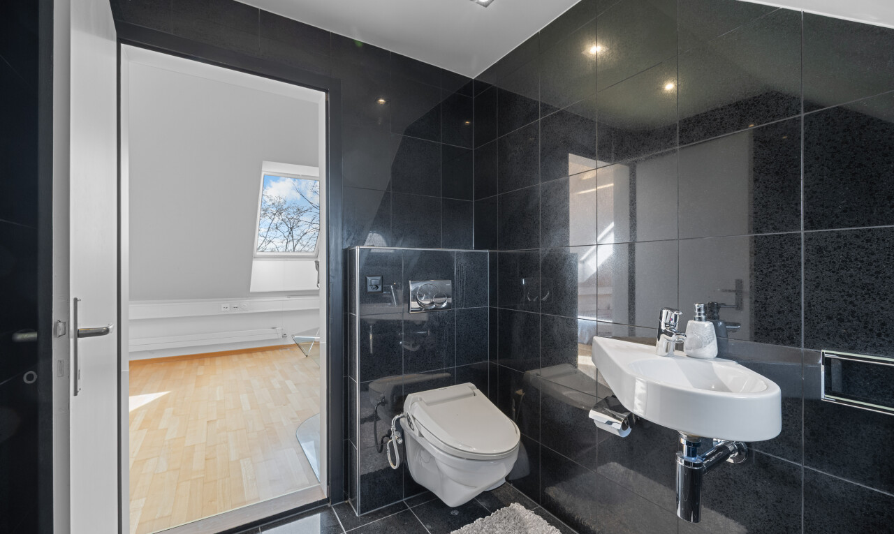 bathroom with tile walls and dark tile patterned floors