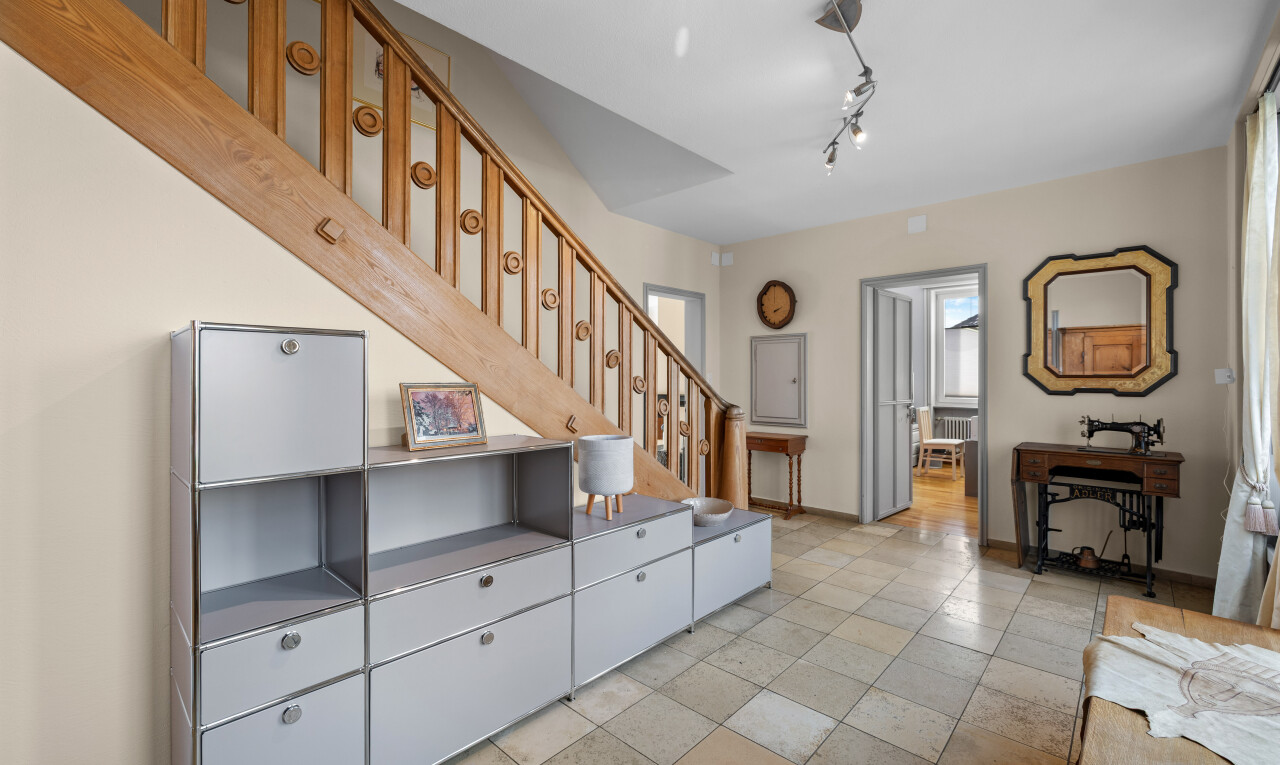 living room with stairs and track lighting