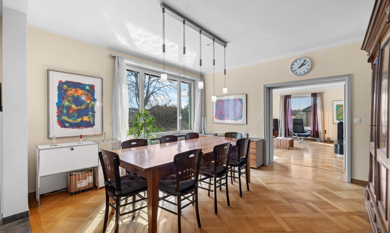 dining area with track lighting and parquet flooring