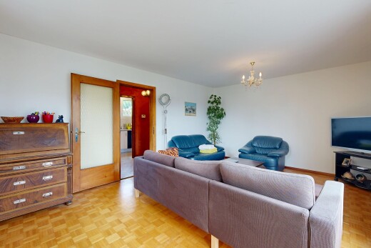 living area with parquet flooring and hanging lights