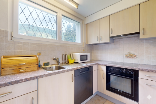 kitchen with black appliances, light stone counters, light tile patterned floors, and decorative backsplash