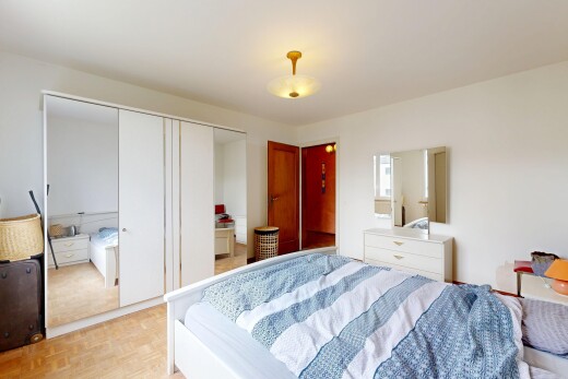 room with parquet flooring and a closet