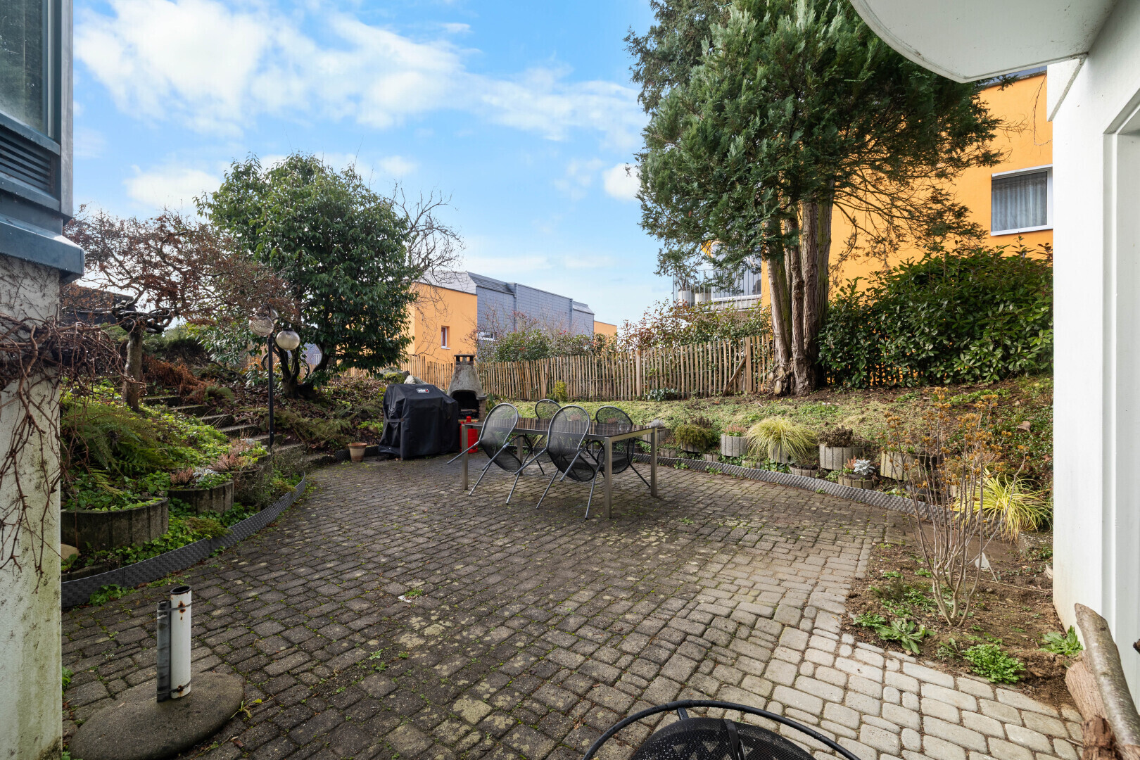 garden with a patio area, a fenced backyard, an outdoor fire pit, and grilling area