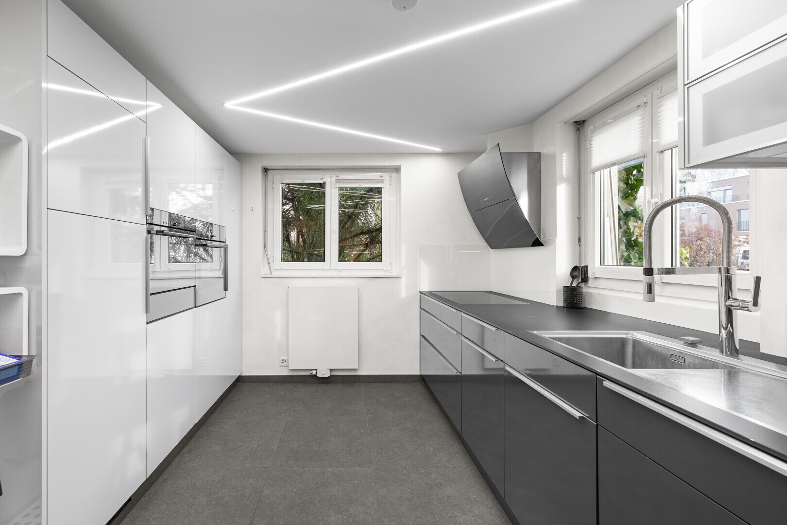 kitchen featuring modern cabinets, oven, and stainless steel counters