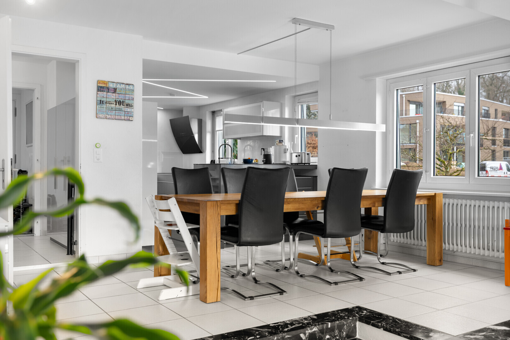 dining area featuring light tile patterned floors, radiator, and track lighting