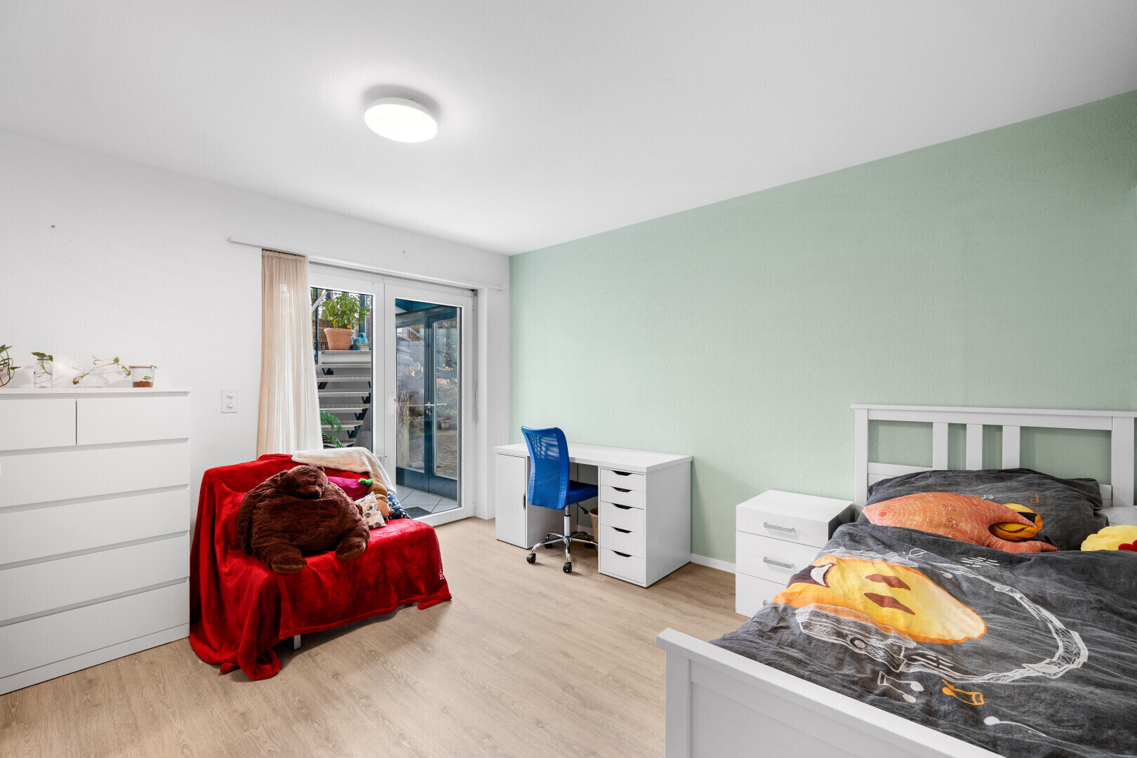 room featuring access to outside, light wood-style flooring, and an office area