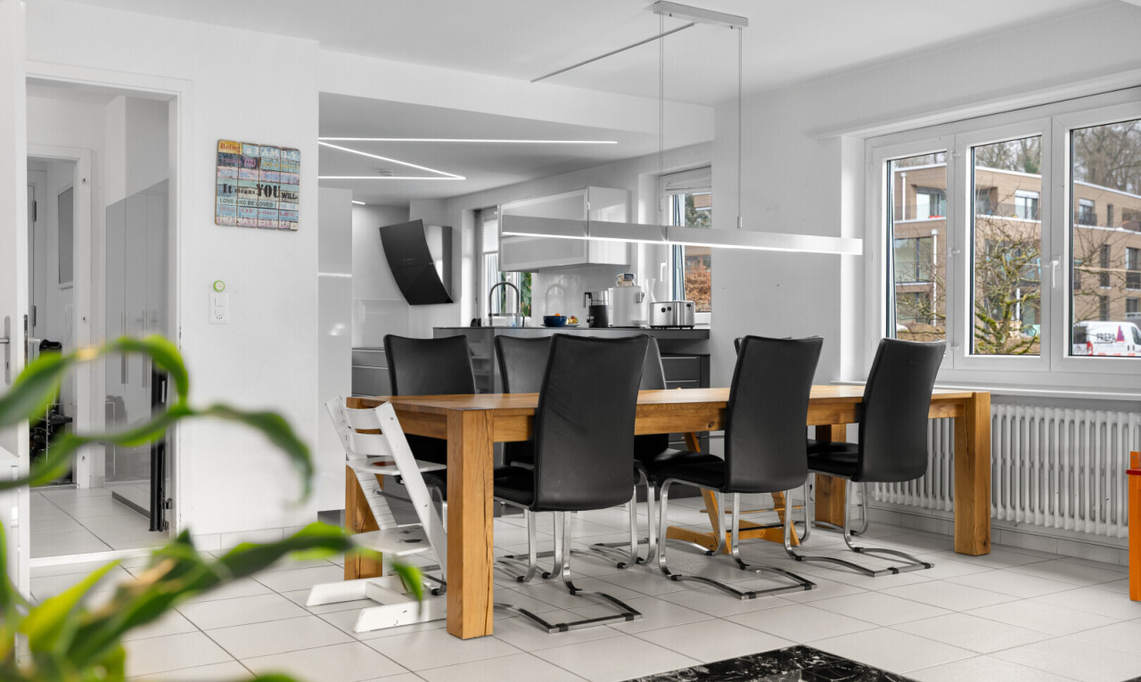 dining area featuring light tile patterned floors, radiator, and track lighting