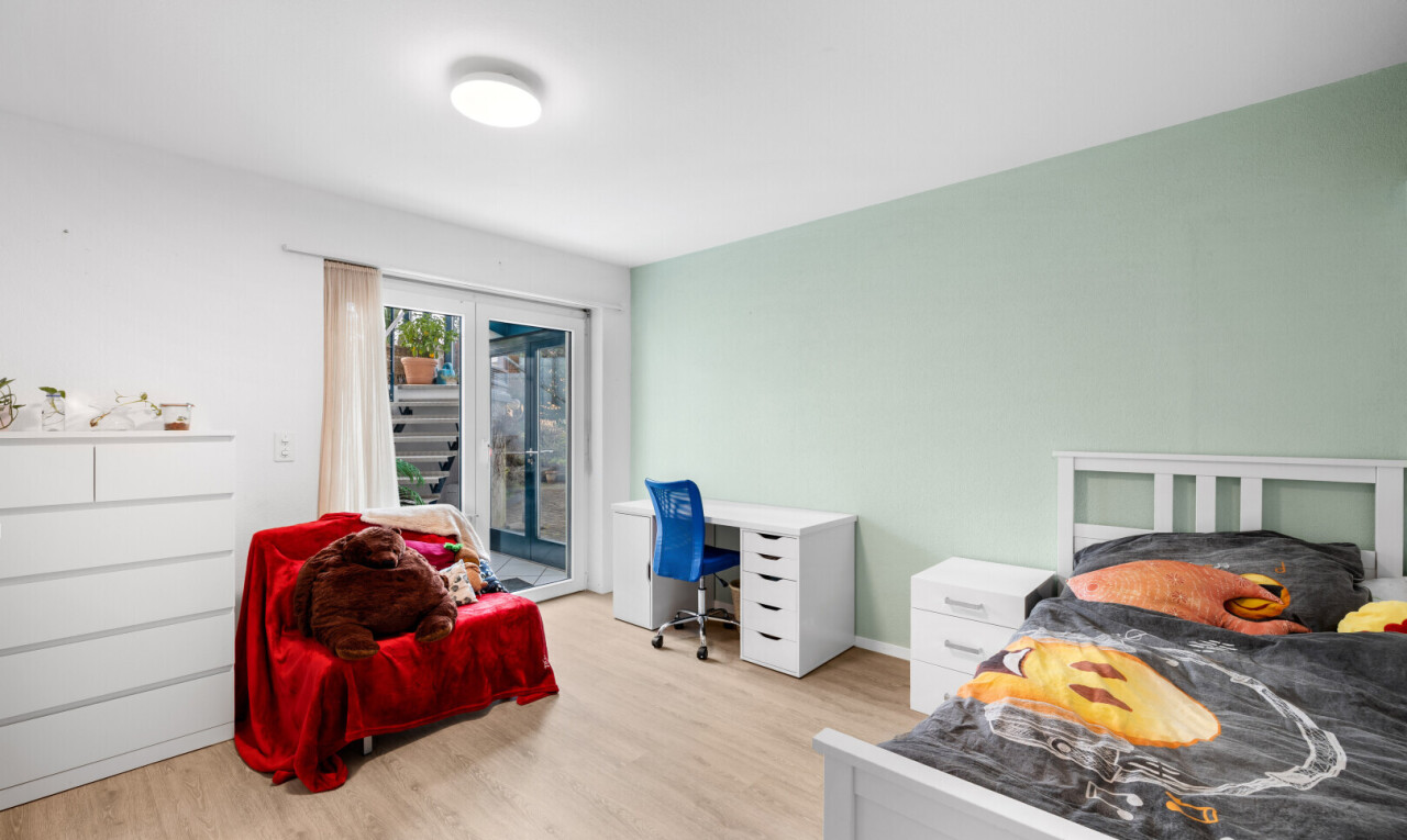room featuring access to outside, light wood-style flooring, and an office area