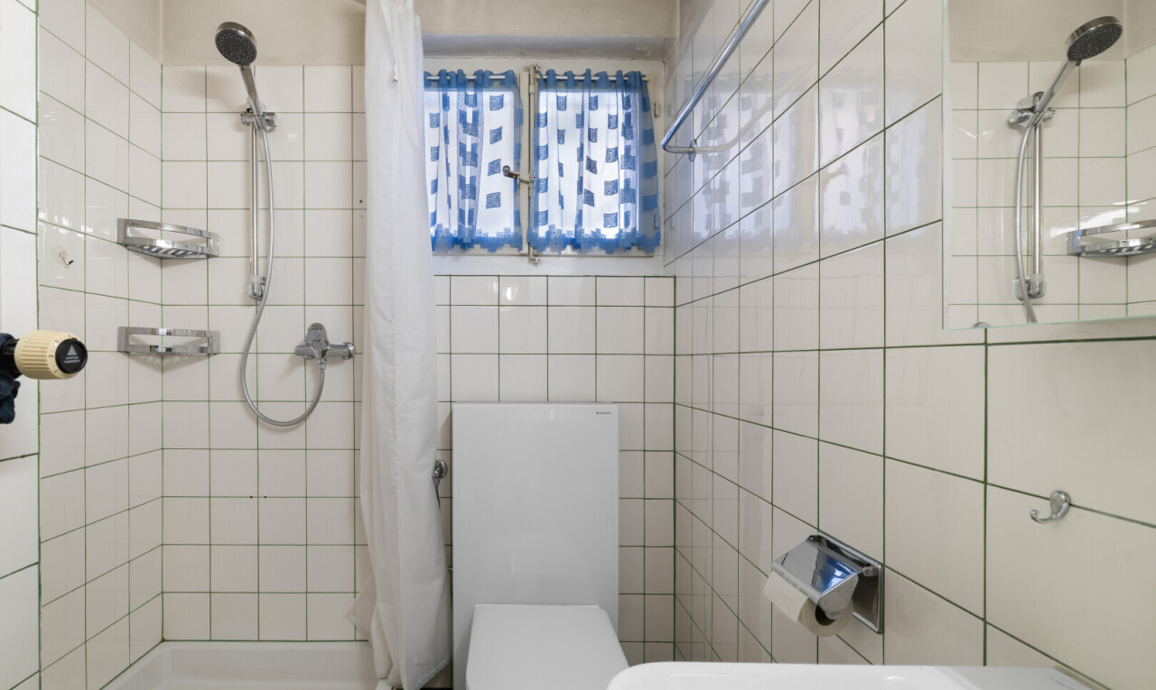 salle de bains avec douche, salle de bain complète, inside property, toilette, et tile wall