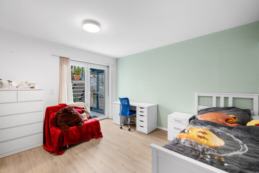 room featuring access to outside, light wood-style flooring, and an office area