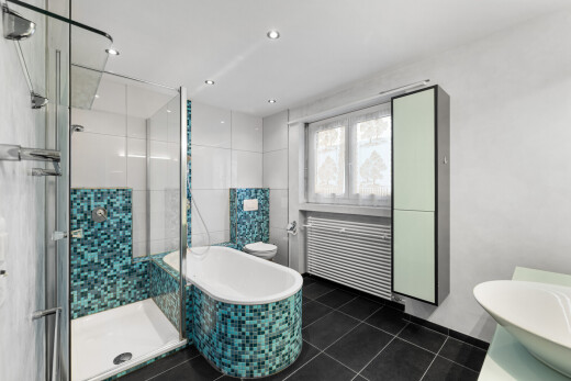 full bathroom featuring a stall shower, radiator heating unit, vanity, a garden tub, and dark tile patterned flooring