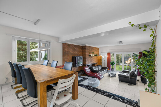 living / dining area featuring healthy amount of natural light and light tile patterned floors